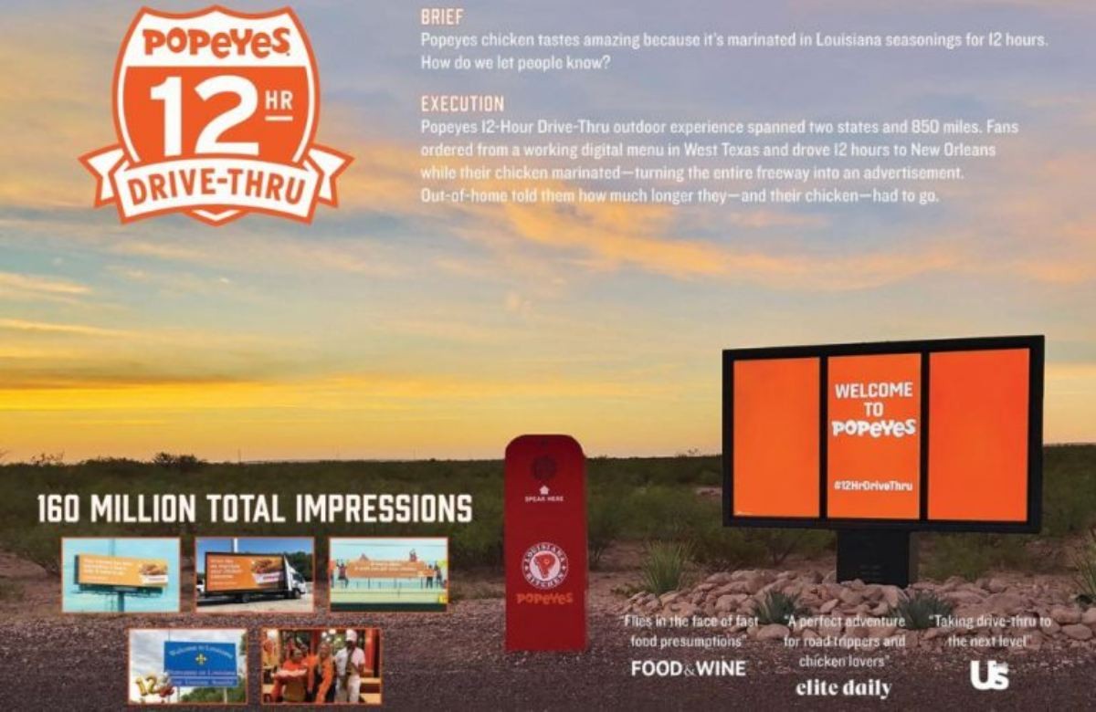 Billboard Popeyes kêu gọi tham gia thử thách “12 Hour Drive Thru” và trải nghiệm hương vị gà đậm đà.